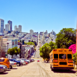 A view of a San Francisco street with a school bus at the forefront.
