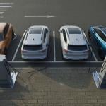 A row of four electric cars getting recharged at an EV charging station.