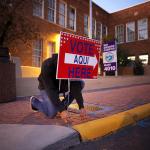 Pollworkers put out signs in El Paso, TX for the midterm election in 2018. 