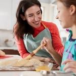 Mom and daughter making Challah bread in the kitchen.