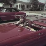 Actor and singer Debbie Reynolds sits in the driver's seat of a red convertible Ford Thunderbird, in Burbank, California, in March 1955.