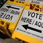 Yellow and white "Vote here" signage stored at a warehouse at the Maricopa County Tabulation and Election Center (MCTEC) ahead of the 2024 Arizona Primary. 