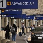 Travelers walk towards Terminal 1 at Oakland International Airport, California.