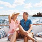 Retired couple sits on a boat on a lake in the Midwest.