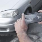 Picture of a car for sale being taken using a smartphone.