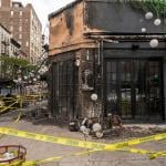 The remains of the outdoor dining and facade of a restaurant after a fire in Chelsea, New York.