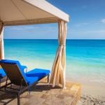 Two chairs set on the pier and gazebo overlooking an idyllic Caribbean beach in Montego Bay, Jamaica.