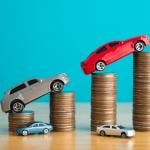 Car figures rising on top of coins.