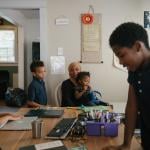 Sameerah Abdullah holds her daughter Maimoonah Abdul Hakeem, 3, while her children Asiyah Jones (left), 6, Dawud Jones, 7, and Musa Moore, 9, do schoolwork in their home in Philadelphia.