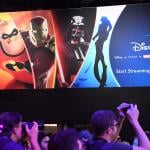 Attendees visit the Disney+ streaming service booth at the D23 Expo in 2019 at the Anaheim Convention Center in Anaheim, California.