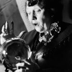 A fortune teller in London's Piccadilly is surprised at what she sees in a crystal ball, circa 1953. 