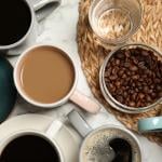 A flatlay of cups of different types of coffee and tea.