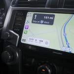 A car navigation system showing map directions to a destination.