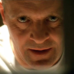 Close-up shot of Anthony Hopkins behind bars in a scene from 'Silence of the Lambs'