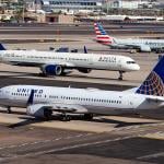 United, Delta and American Airlines planes line up in Phoenix Sky Harbor International Airport.