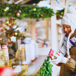 Woman buys coffee from outdoor kiosk in winter