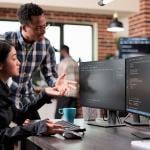 Two members of a cybersecurity team configuring data issues.