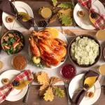 A traditional homemade Thanksgiving feast with autumnal decor.