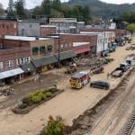 Debris and river mud being hauled off the French Broad River area after Hurricane Helene in Marshal, NC.