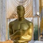 An Oscar statuette displayed near the red carpet area of an Oscars Award show.