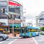 Bus and cars driving in the streets of a downtown area in a city in Maryland.