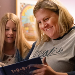 Bridget Everett reading to a child in a scene from 'Somebody Somewhere'