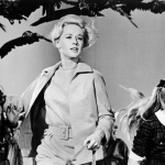 American actor Tippi Hedren and a group of children run away from the attacking crows in a still from the film 'The Birds' directed by Alfred Hitchcock. 