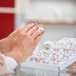 Woman trying on a diamond engagement ring.