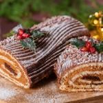 Traditional Christmas chocolate yule log with festive decorations.