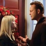 Reese Witherspoon and Vince Vaughn stand in front of a door with a wreath on it in the movie 'Four Christmases.'