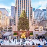 Ice skaters in front of the Christmas tree at the Rockefeller center. 