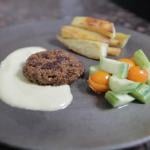  sautéed patty made of soy pulp inoculated with Neurospora intermedia fermented by Hill-Maini. The patty is joined by a cashew cream sauce, baked yams, and a tomato and cucumber salad.