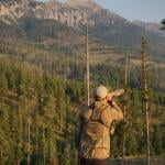 Man looking over a mountainous area and sightseeing. 