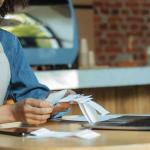 A female small business owner looking through receipts for tax filing.