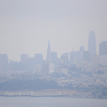 Smoke from wildfires causes hazy conditions over San Francisco skyline on sunny day