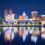 A view of Peoria, Illinois' downtown skyline and lake at dusk.