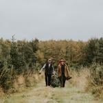 Two men hauling a Christmas tree.