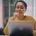 Person reading over email on their laptop.