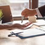 A landlord hands over keys of property to approved tenant.