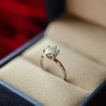 A diamond engagement ring safely kept in a jewelry box/ring holder.