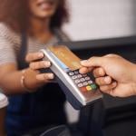 A small business barista receiving payment through a card purchase.