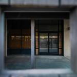 A shuttered door at a homeless shelter in Anaheim that is permanently shut down and partially boarded up.