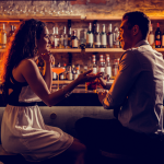 Young couple talking at a bar counter