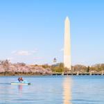 A couple on a pedal boat at the Tidal Basin with a view of the Washington Monument.