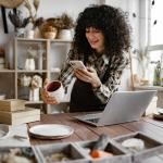 A potter and small business owner takes photos of their ceramic items for sale.