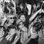 Sreaming fans cheer for rock and roll musicians on American Bandstand in the mid 1960s.