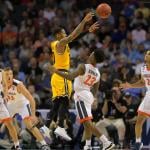 UMBC guard Jairus Lyles (10) and four UVA defenders during the 2018 Men's NCAA basketball tournament at the Spectrum Center in Charlotte, North Carolina.