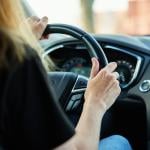 A woman driving a car.