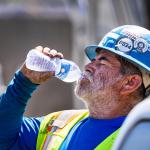 A construction worker takes a water break during a heat wave in California. 