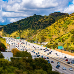 Aerial view of California Interstate 405 near Los Angeles surrounded by green hills